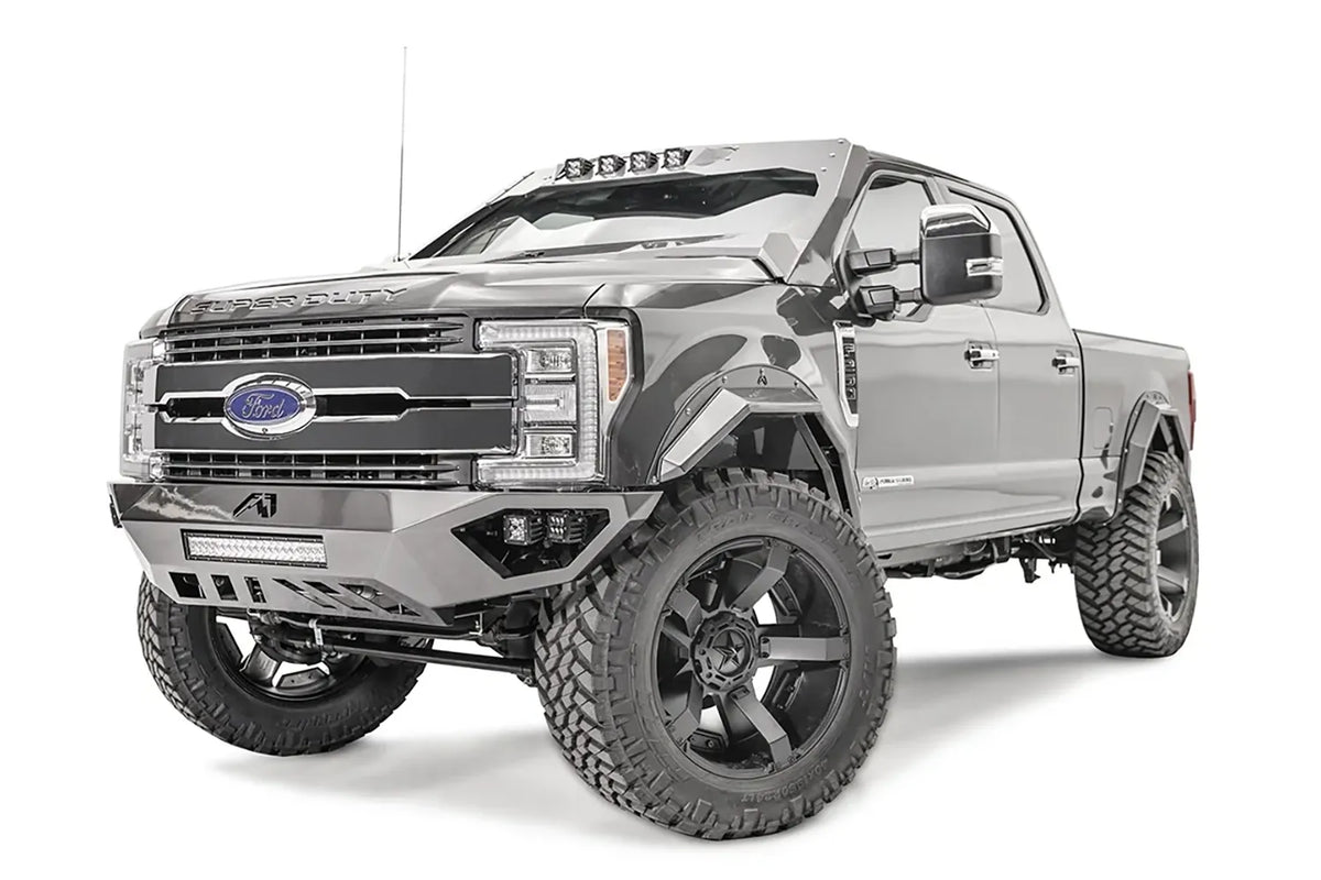 Fab Fours ViCowl on a lifted gray Ford Super Duty, front driver-side view, with the angular steel cowl, four cube lights over the windshield and matching Fab Fours front bumper