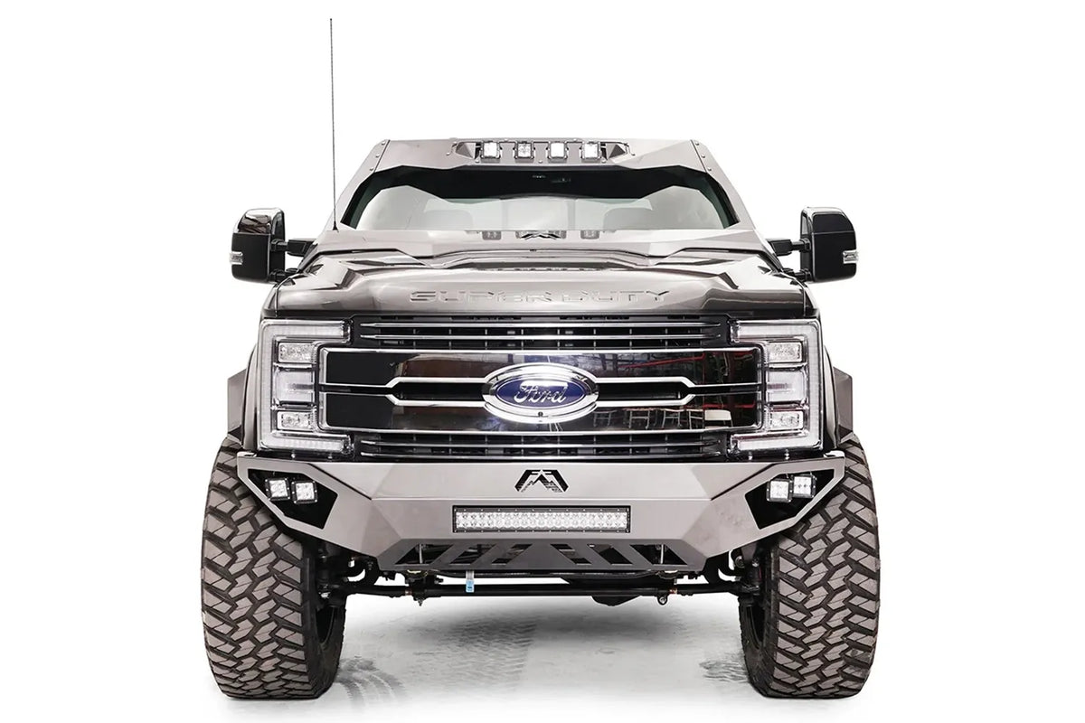 Fab Fours ViCowl on a gray Ford Super Duty, front view, showing the steel cowl wrapping the windshield frame with four roof-mounted cube lights above a Fab Fours front bumper