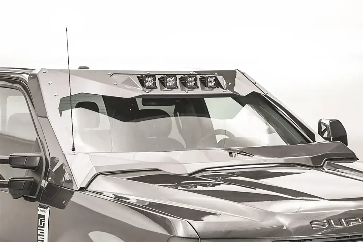 Fab Fours ViCowl four-light insert on a gray Ford Super Duty, front driver-side view, showing four cube pod lights mounted across the top of the ViCowl windshield frame