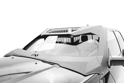 Fab Fours ViCowl on a silver Ram 2500, close-up three-quarter view of the windshield area, showing the frame cover, honeycomb mesh vent, and A-pillar wrap