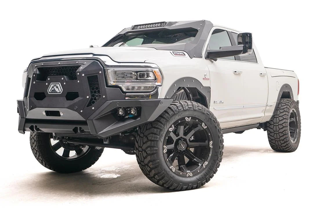 Fab Fours ViCowl on a white Ram 2500, front three-quarter view, showing the windshield frame cover, LED light bar, and A-pillar wrap