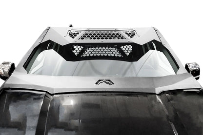 Fab Fours ViCowl on a black Ford F-150, front view over the hood, showing the matte black steel cowl framing the windshield with honeycomb mesh visor panels and Fab Fours logo