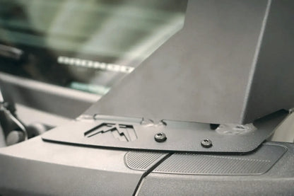 Close-up of the Fab Fours ViCowl mounting bracket on a Ford Bronco cowl, showing the Fab Fours logo cutout and bolted steel base