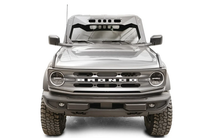 Fab Fours ViCowl on a gray Ford Bronco, front view, showing the matte black steel cowl with slotted visor cutouts framing the windshield