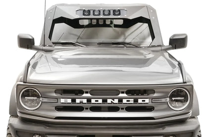 Fab Fours ViCowl on a gray Ford Bronco, front view, showing the steel cowl with the optional four-light insert in the visor above the windshield