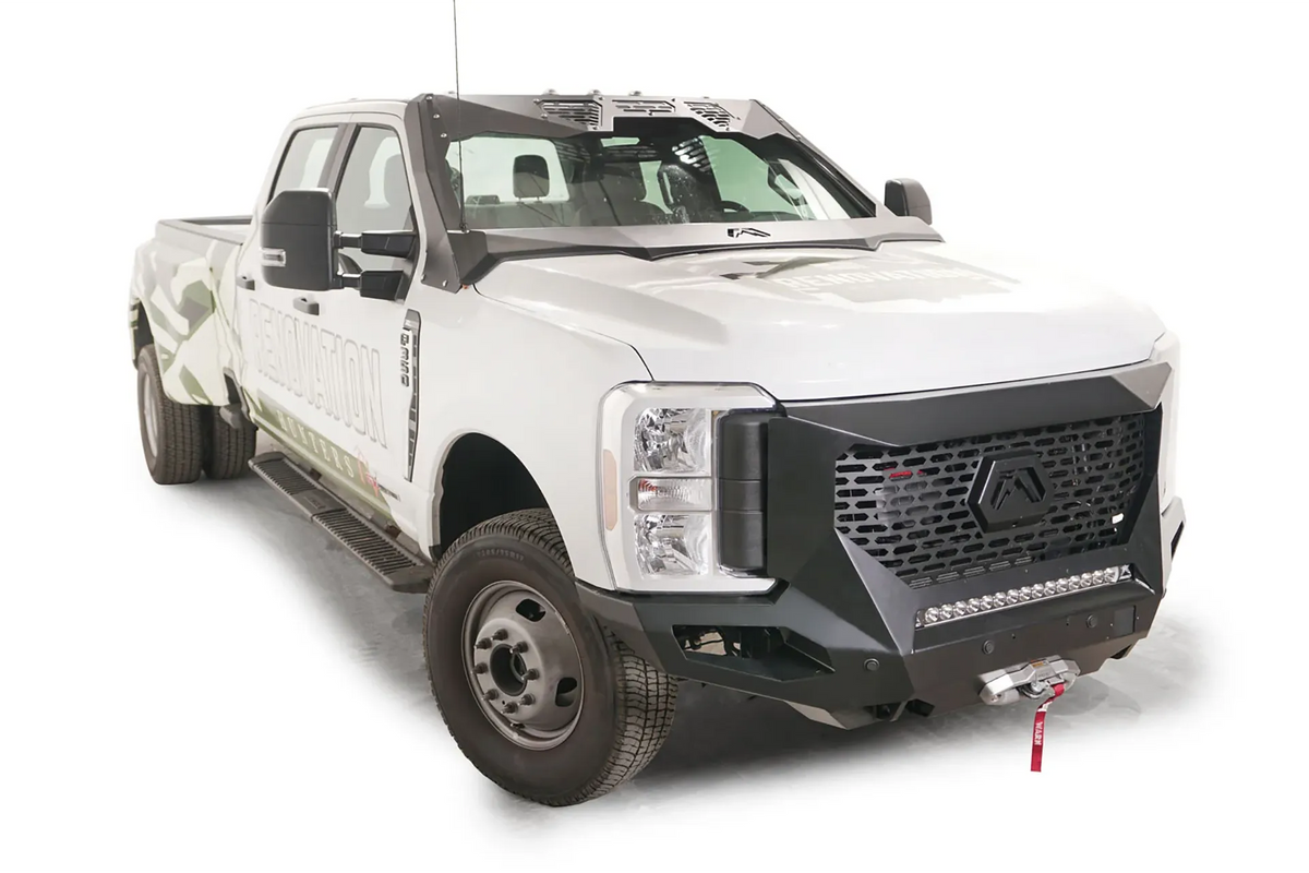 Fab Fours ViCowl Windshield Protection on a white 2023+ Ford F-350 Super Duty dually, front passenger-side view, with the steel cowl framing the windshield and a matching Fab Fours front bumper with LED light bar and winch